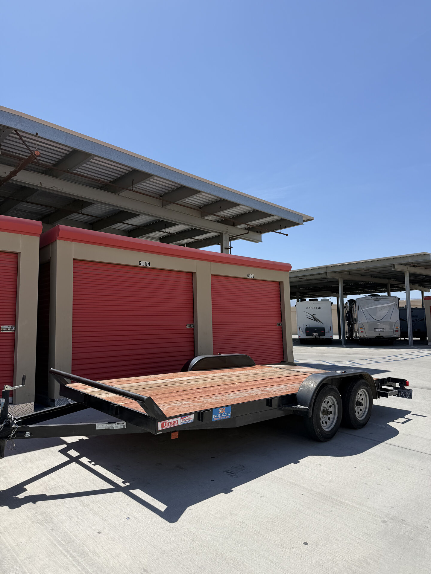 Desert Choice Rentals flatbed utility trailer with wood deck and tandem axles